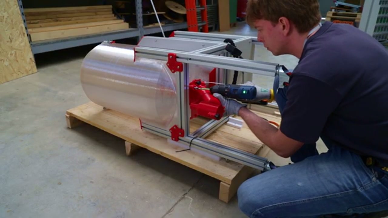 Attaching the red caster wheel to the base frame