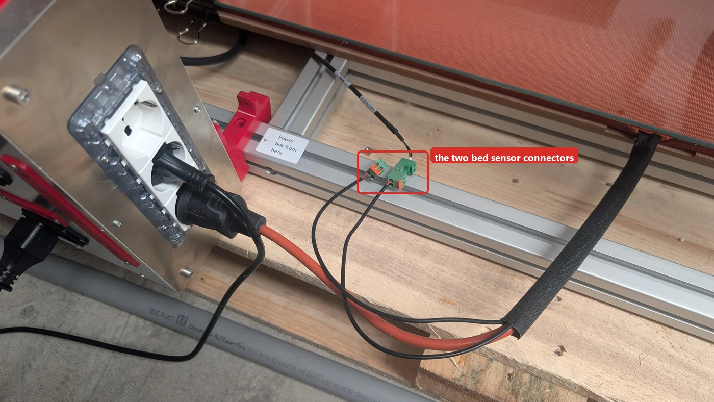 Where the bed sensor connectors sit — on the rail under the bed, beside the socket plate
