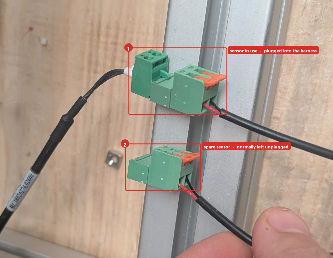 The two bed sensor connectors on the frame rail: one mated to the harness, the second sitting unplugged