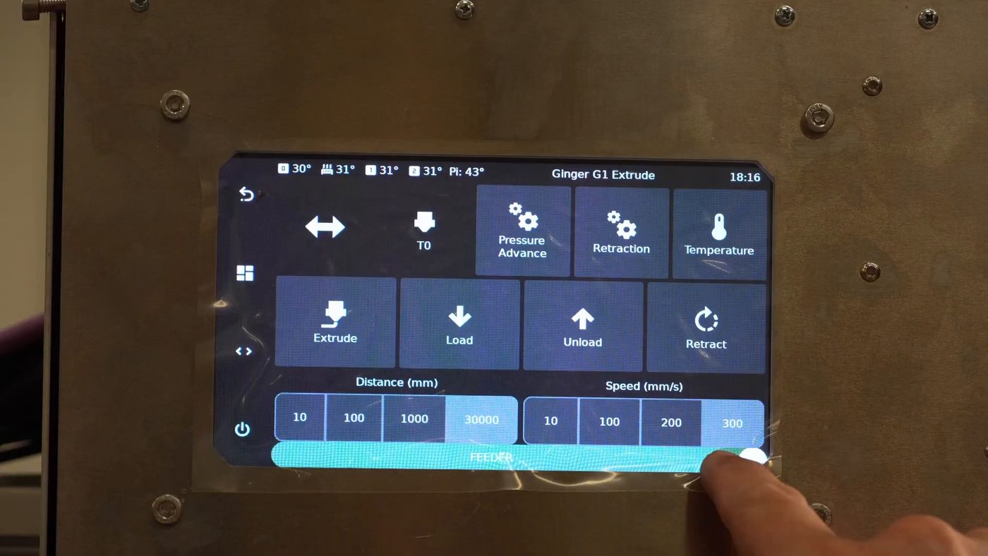 The G1 display on the Extrude screen. Along the bottom a wide FEEDER toggle is switched on, above rows of Extrude, Load, Unload and Retract buttons and the distance and speed presets
